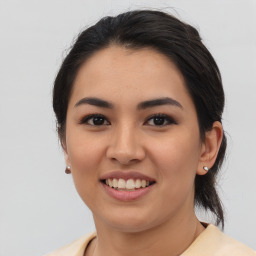 Joyful asian young-adult female with medium  brown hair and brown eyes