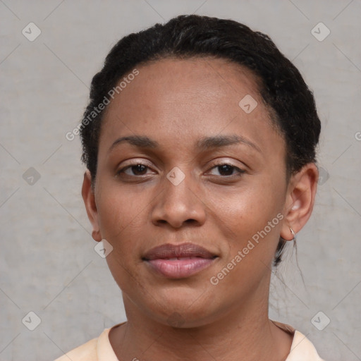 Joyful black young-adult female with short  black hair and brown eyes