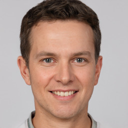 Joyful white adult male with short  brown hair and grey eyes