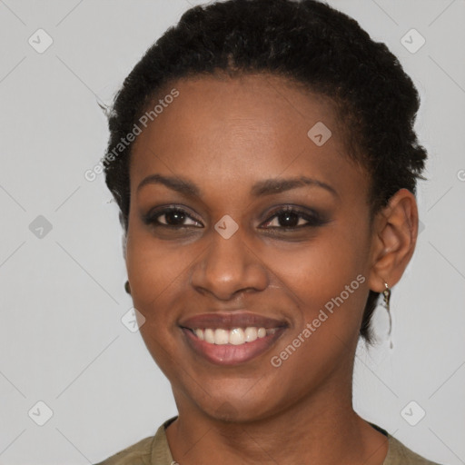 Joyful black young-adult female with short  brown hair and brown eyes