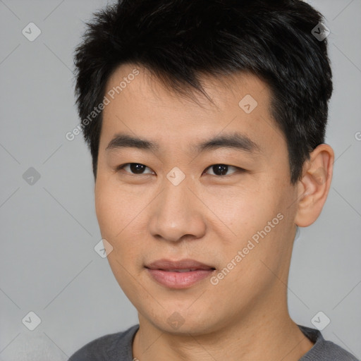 Joyful asian young-adult male with short  brown hair and brown eyes