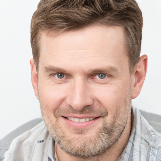 Joyful white adult male with short  brown hair and grey eyes