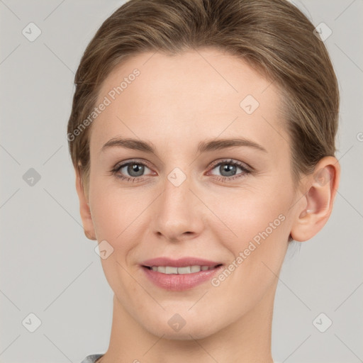 Joyful white young-adult female with short  brown hair and grey eyes