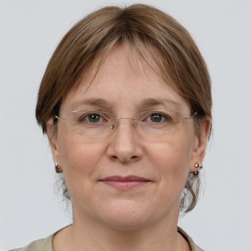 Joyful white adult female with medium  brown hair and grey eyes