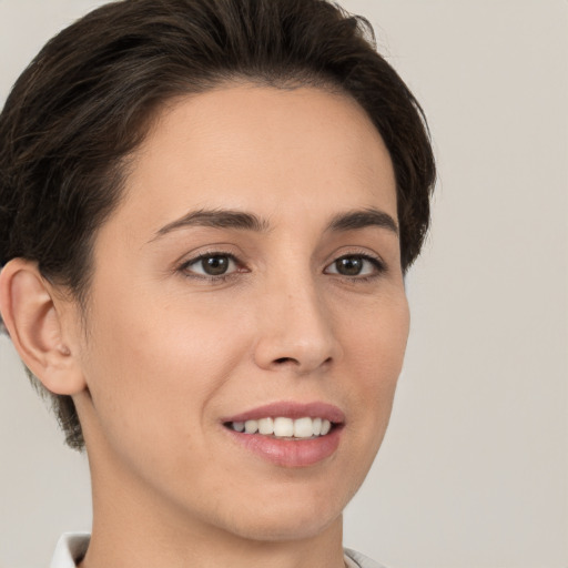 Joyful white young-adult female with short  brown hair and brown eyes