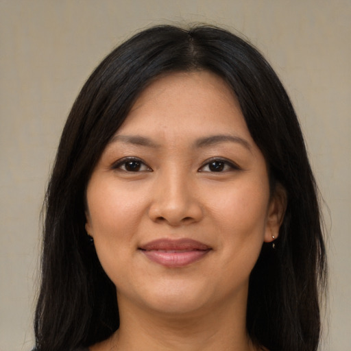 Joyful asian young-adult female with long  brown hair and brown eyes
