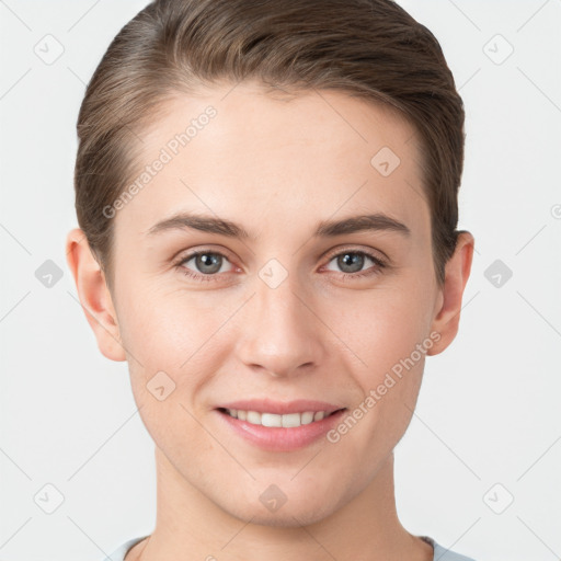 Joyful white young-adult female with short  brown hair and grey eyes