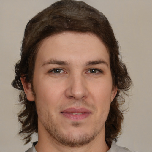 Joyful white young-adult male with medium  brown hair and brown eyes