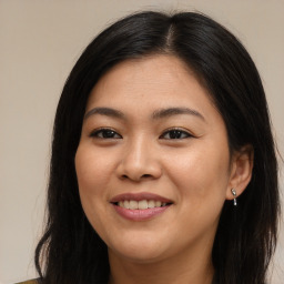 Joyful asian young-adult female with long  brown hair and brown eyes