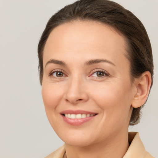 Joyful white young-adult female with medium  brown hair and brown eyes