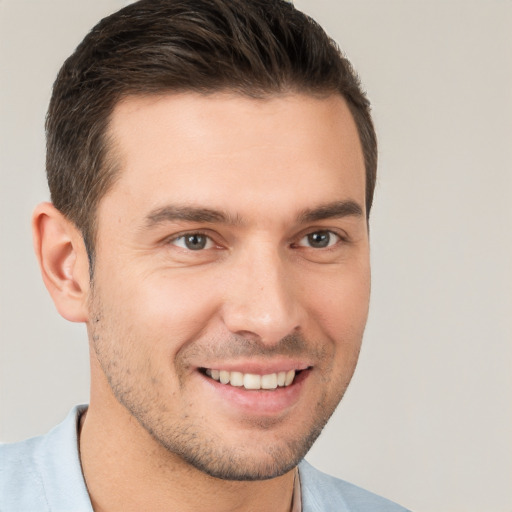 Joyful white young-adult male with short  brown hair and brown eyes