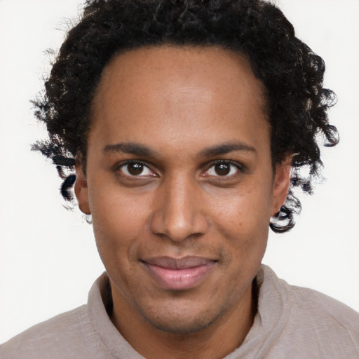 Joyful black young-adult male with short  brown hair and brown eyes