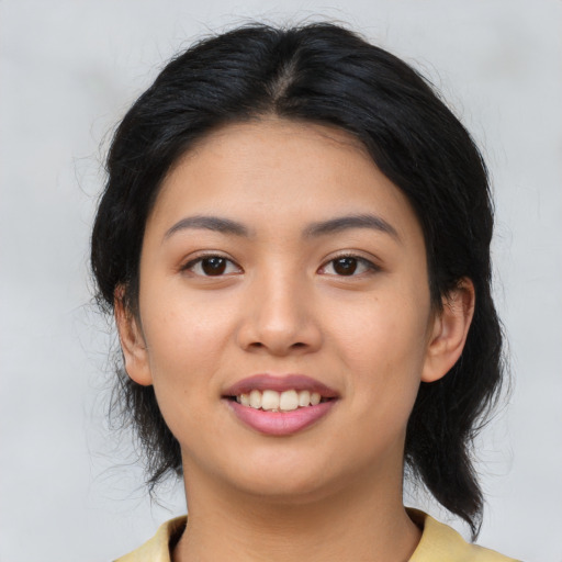 Joyful asian young-adult female with medium  black hair and brown eyes