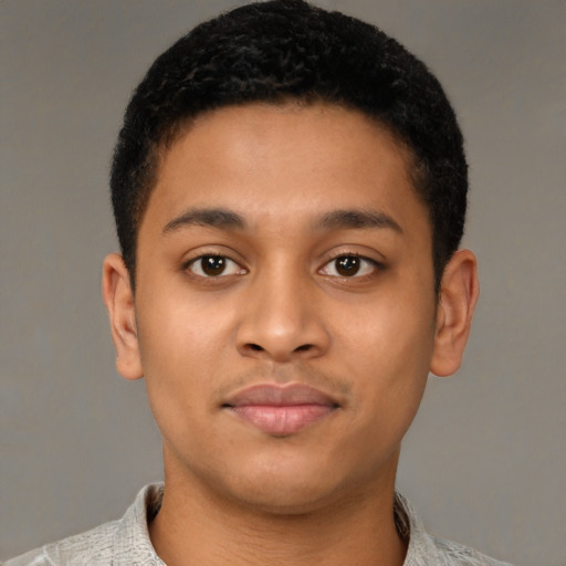 Joyful latino young-adult male with short  brown hair and brown eyes