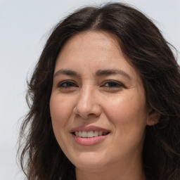 Joyful white adult female with long  brown hair and brown eyes