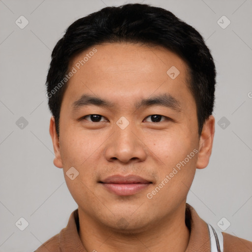 Joyful asian young-adult male with short  black hair and brown eyes