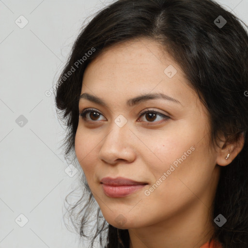 Joyful latino young-adult female with long  brown hair and brown eyes