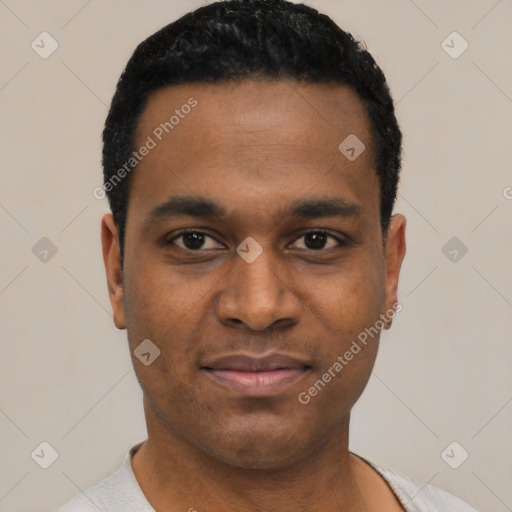 Joyful black young-adult male with short  black hair and brown eyes