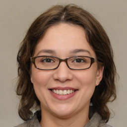 Joyful white adult female with medium  brown hair and brown eyes