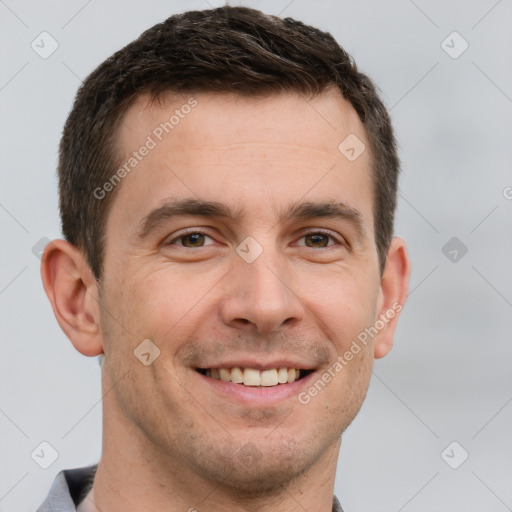 Joyful white young-adult male with short  brown hair and grey eyes