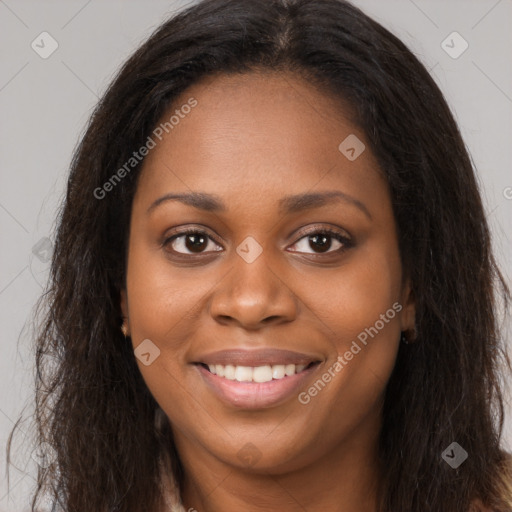 Joyful black young-adult female with long  brown hair and brown eyes