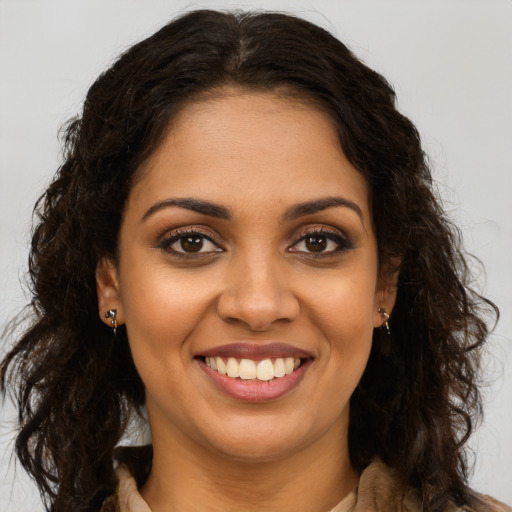 Joyful latino young-adult female with long  brown hair and brown eyes