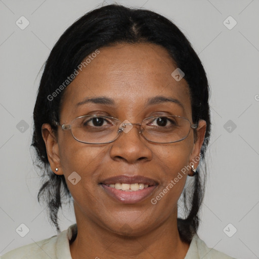 Joyful black adult female with medium  brown hair and brown eyes