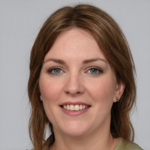 Joyful white young-adult female with medium  brown hair and blue eyes