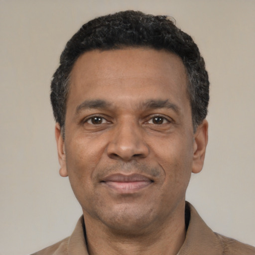 Joyful latino adult male with short  black hair and brown eyes
