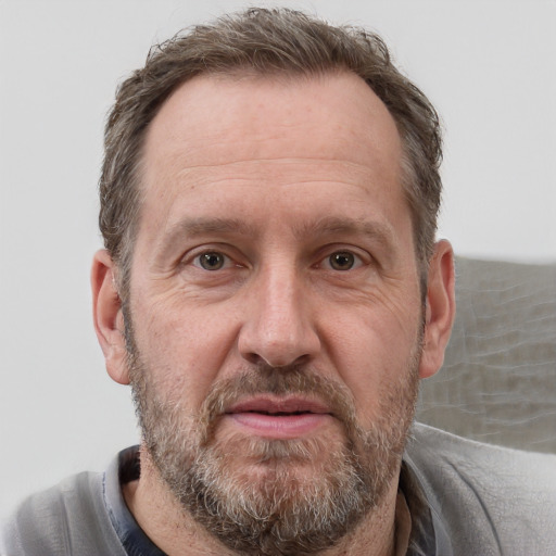 Joyful white adult male with short  brown hair and grey eyes