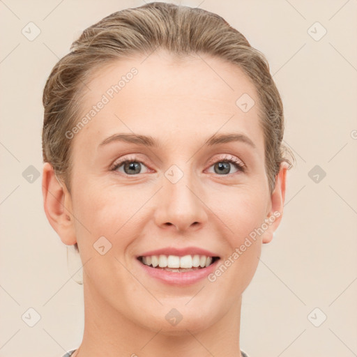 Joyful white young-adult female with short  brown hair and grey eyes