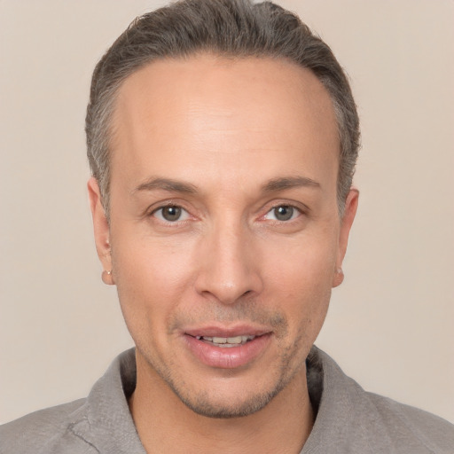 Joyful white adult male with short  brown hair and brown eyes