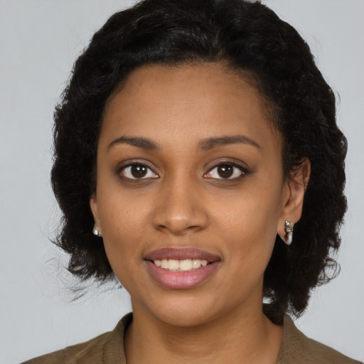 Joyful black young-adult female with medium  black hair and brown eyes