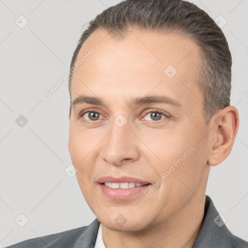 Joyful white adult male with short  brown hair and brown eyes