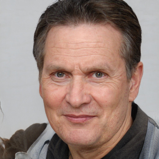 Joyful white middle-aged male with short  brown hair and brown eyes