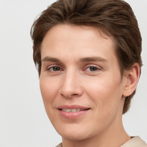 Joyful white young-adult female with short  brown hair and grey eyes