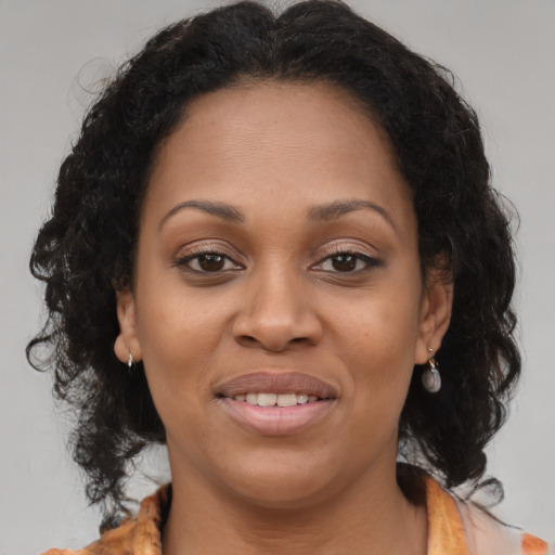 Joyful black young-adult female with medium  brown hair and brown eyes
