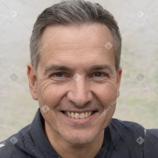 Joyful white adult male with short  brown hair and brown eyes