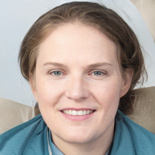 Joyful white young-adult female with medium  brown hair and blue eyes