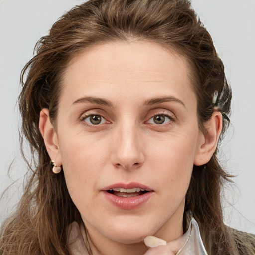 Joyful white young-adult female with long  brown hair and blue eyes