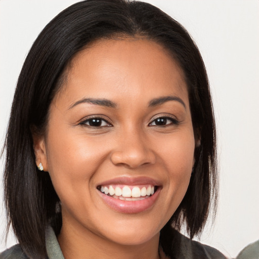 Joyful latino young-adult female with long  brown hair and brown eyes