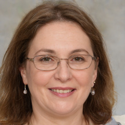 Joyful white adult female with medium  brown hair and grey eyes