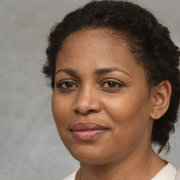 Joyful black young-adult female with medium  brown hair and brown eyes