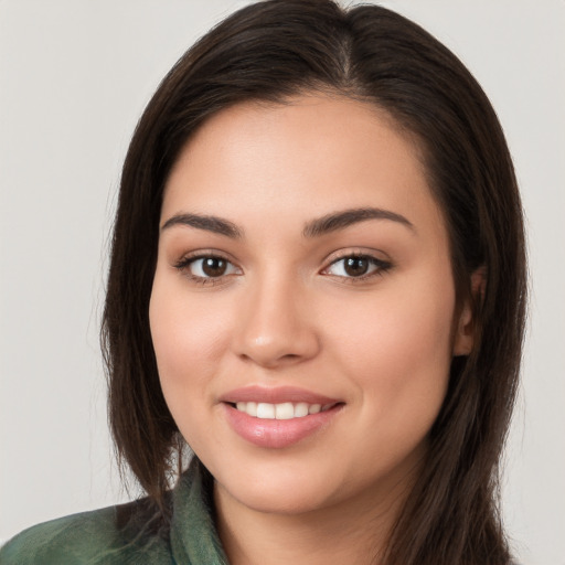 Joyful white young-adult female with long  brown hair and brown eyes