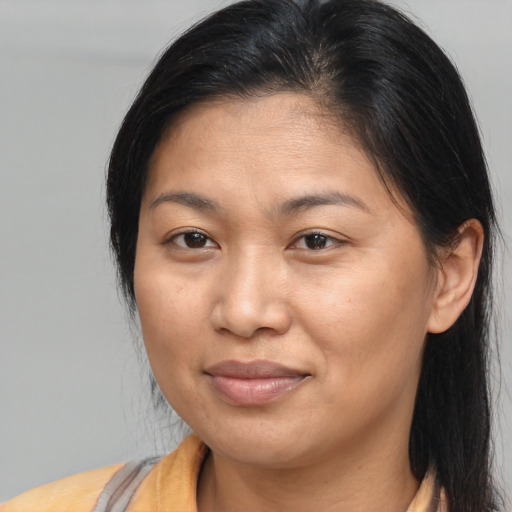 Joyful asian adult female with medium  brown hair and brown eyes