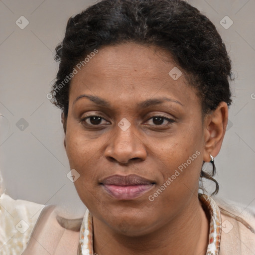 Joyful black adult female with short  brown hair and brown eyes