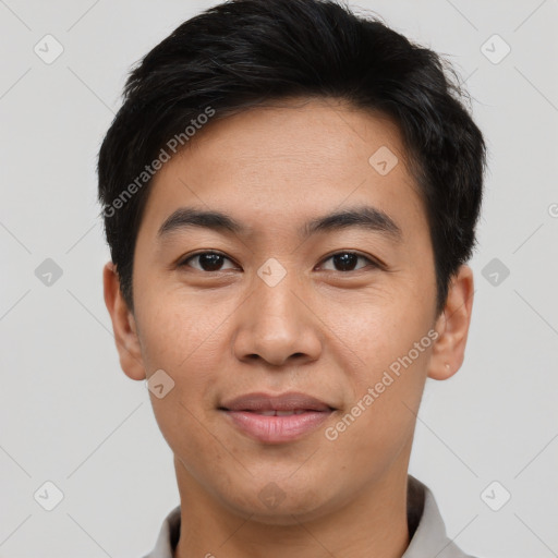 Joyful asian young-adult male with short  black hair and brown eyes