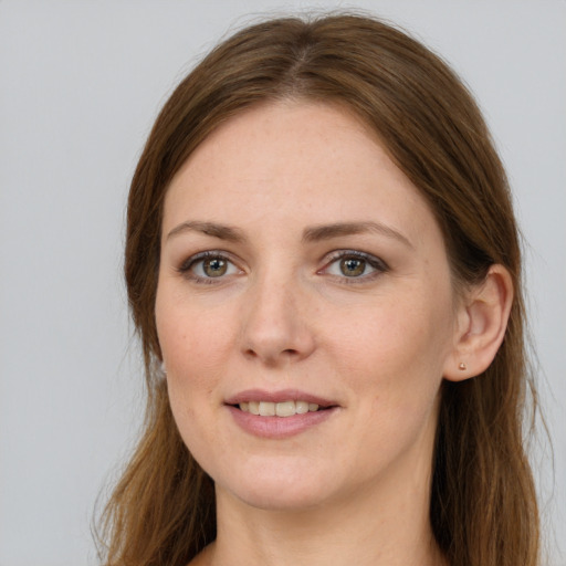 Joyful white young-adult female with long  brown hair and grey eyes