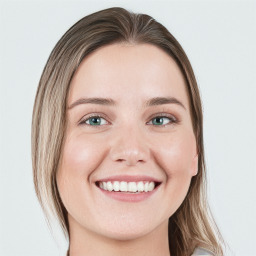 Joyful white young-adult female with long  brown hair and green eyes