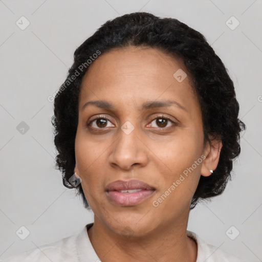 Joyful black adult female with short  black hair and brown eyes